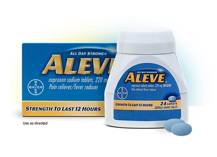 a bottle, box, and a single loose aleve (naproxen) caplet for pain relief